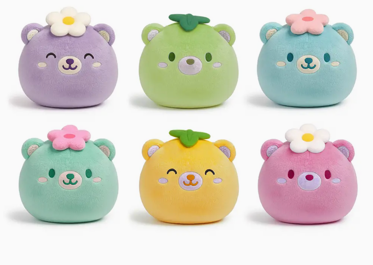 Six colorful round plush mochi bears with flower and leaf decorations, soft textured squish toys for sensory play.