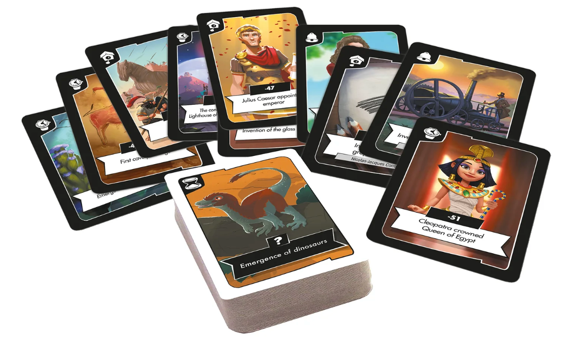 Deck and spread of Timeline Twist game cards showing historical events with colorful illustrations and timeline icons