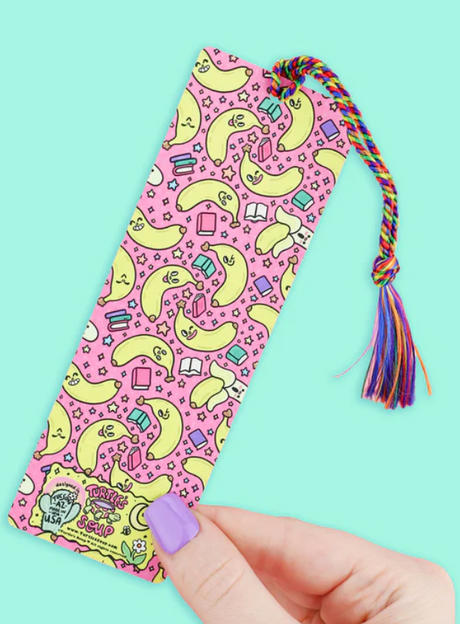Colorful bookmark with playful banana pattern, rainbow tassel, and cheerful design perfect for marking reading spots in books.