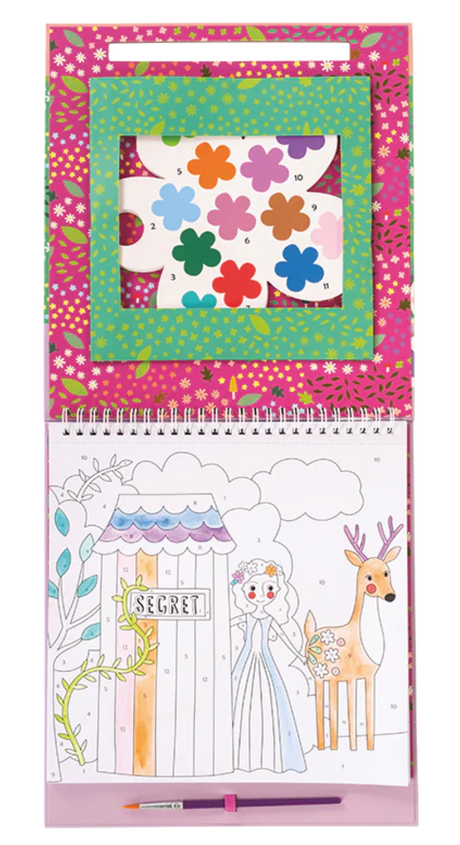 Open spiral paint by numbers pad showing a fairy tale scene with princess and deer and flower-shaped paint palette