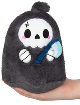 Small plush toy of a friendly grim reaper holding a blue scythe, fitting comfortably in one hand.