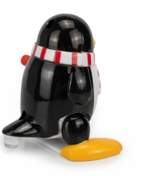 Black wind-up penguin toy wearing a red and white striped scarf with orange feet on a white background
