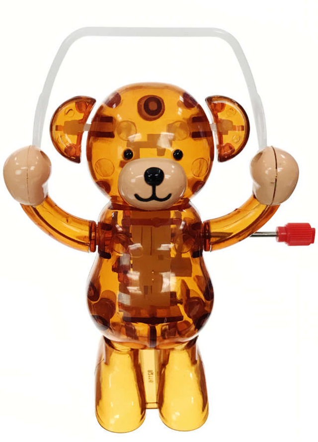 Transparent brown teddy bear toy with button eyes, raised arms, and a red wind-up key on its side