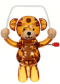 Transparent brown teddy bear toy with button eyes, raised arms, and a red wind-up key on its side
