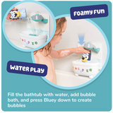 Child playing with Bluey bath toy filling the tub with water and creating bubbles by pressing down the figure