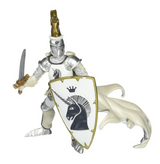 Toy warrior figure in silver armor with white flowing robe holding sword and unicorn shield ready for battle