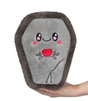 Soft gray coffin-shaped plush toy with a smiling face and red heart embroidery held in hand