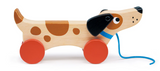 Wooden puppy toy with bright red wheels and blue leash, designed for toddlers to pull and play with.
