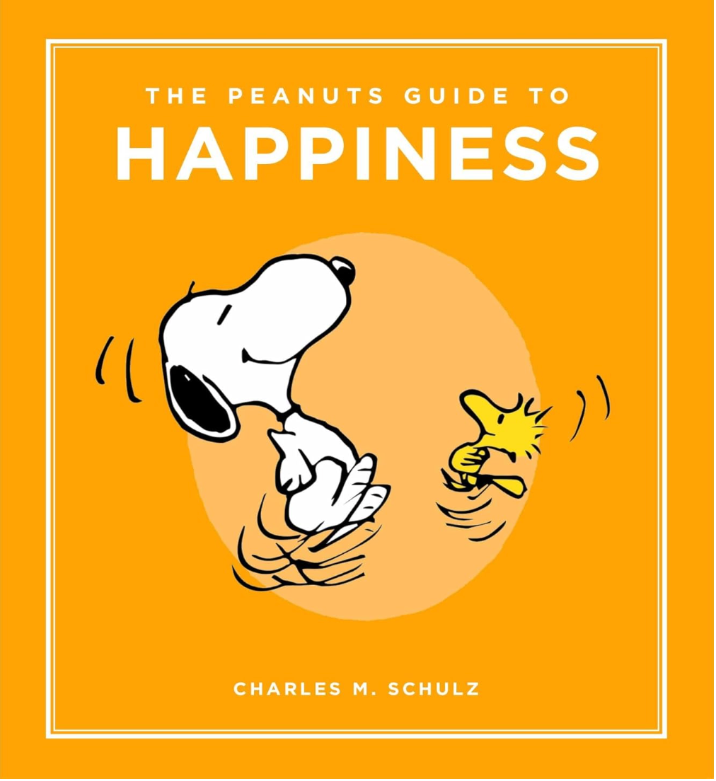Cover of The Peanuts Guide to Happiness featuring Snoopy and Woodstock joyfully dancing on an orange background