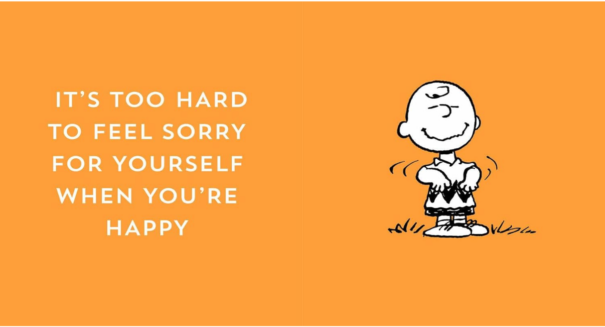 Charlie Brown smiling and dancing with the quote about happiness on an orange background.