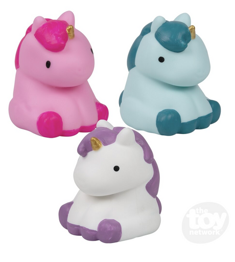 Three colorful squishy unicorn fidget toys in pink, blue, and white with gold horns sitting together