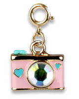 Gold camera charm with sparkling lens and turquoise heart details, perfect for adding a playful touch to any accessory collection