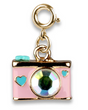 Gold camera charm with sparkling lens and turquoise heart details, perfect for adding a playful touch to any accessory collection