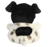 Plush puppy with black floppy ears and white fur with black spots seen from the back showing compact paws and tail