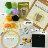 Woolbuddy felting kit with colorful wool, bamboo hoop, foam pad, guide, and Mystic Garden Cat wool felt design