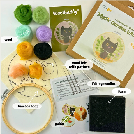 Woolbuddy felting kit with colorful wool, bamboo hoop, foam pad, guide, and Mystic Garden Cat wool felt design