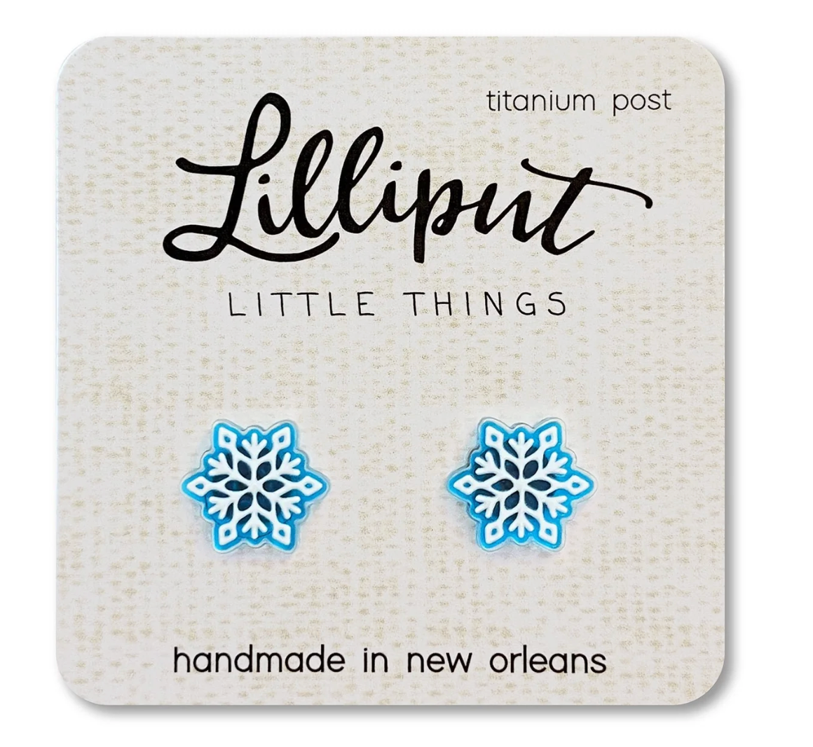 Blue and white snowflake earrings with titanium posts displayed on a handmade Lilliput Little Things card