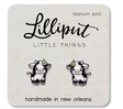 Cute baby cow stud earrings with titanium posts on a card, designed for sensitive ears and waterproof wear