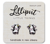 Cute baby cow stud earrings with titanium posts on a card, designed for sensitive ears and waterproof wear
