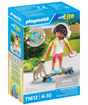 Playmobil figure with headphones on skateboard accompanied by small dog on grassy background