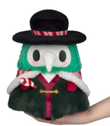 Soft plush figure with green fur, white beak mask, black wide-brimmed hat, festive cape, and striped candy cane accessory