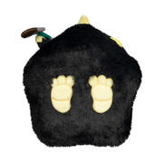 Soft black plush shaped like a round animal with light yellow paw prints and small decorative horns