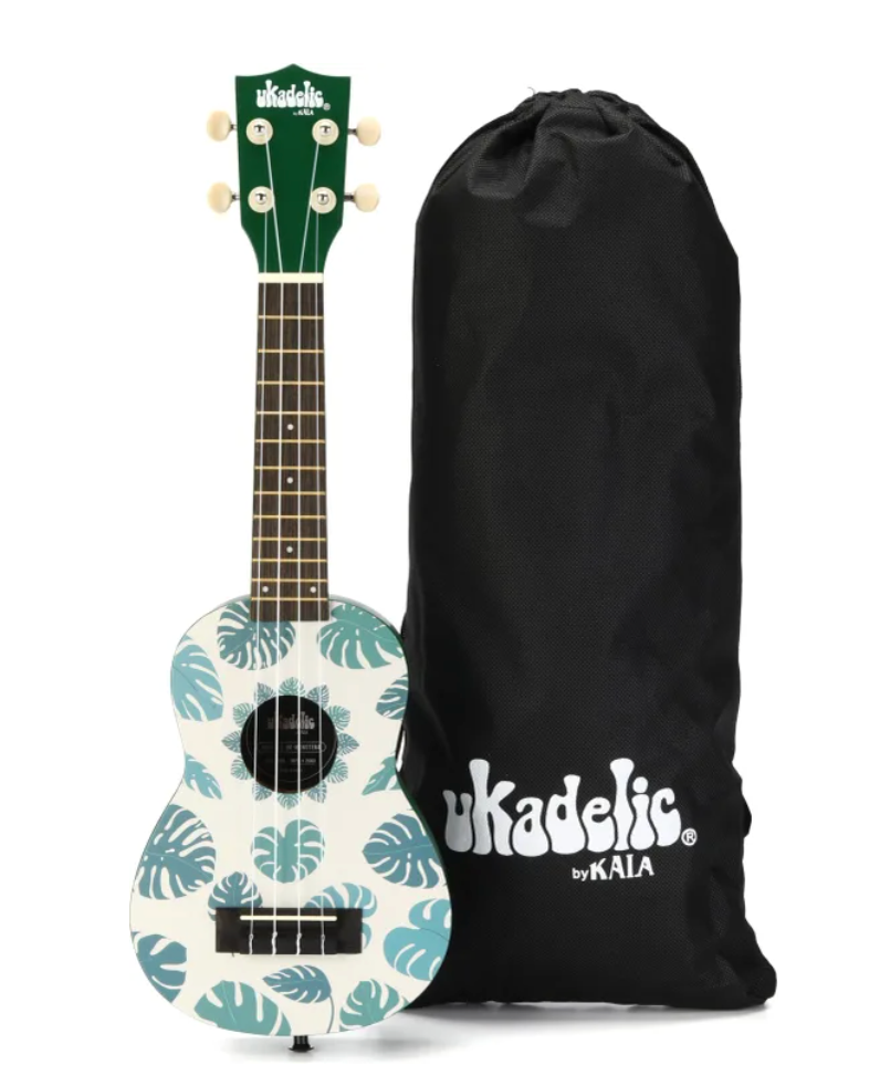 Ukulele with teal tropical leaf pattern on white body, dark green headstock, and black carrying bag with white logo text