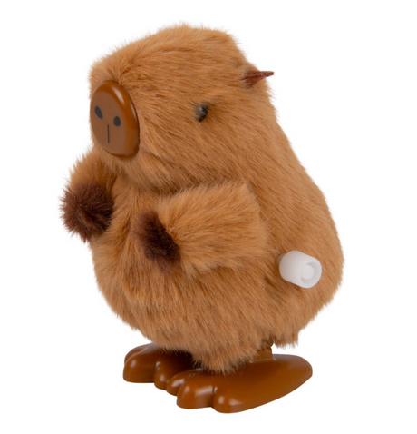 Small fluffy brown toy with rounded body, simple face, furry arms, and large flat feet with a wind-up key on side