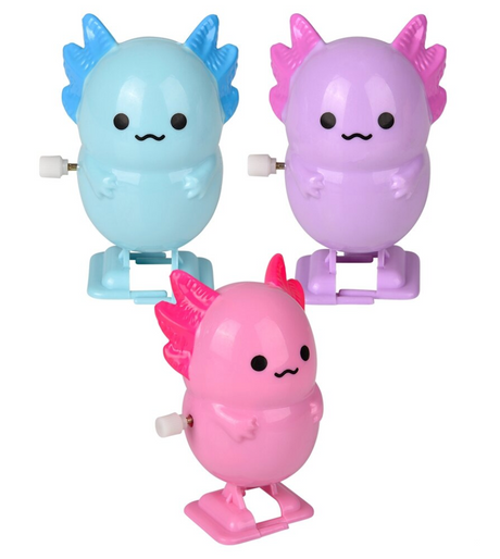 Three pastel-colored wind-up toys shaped like cute creatures with small arms and wing-like fins in blue, purple, and pink