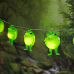 Frog String Lights glowing green frog lights hanging along a wire in a forest