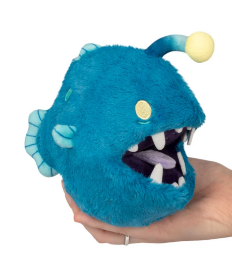 Anglerfish Snackers blue plush anglerfish puppet with an open mouth held in a hand