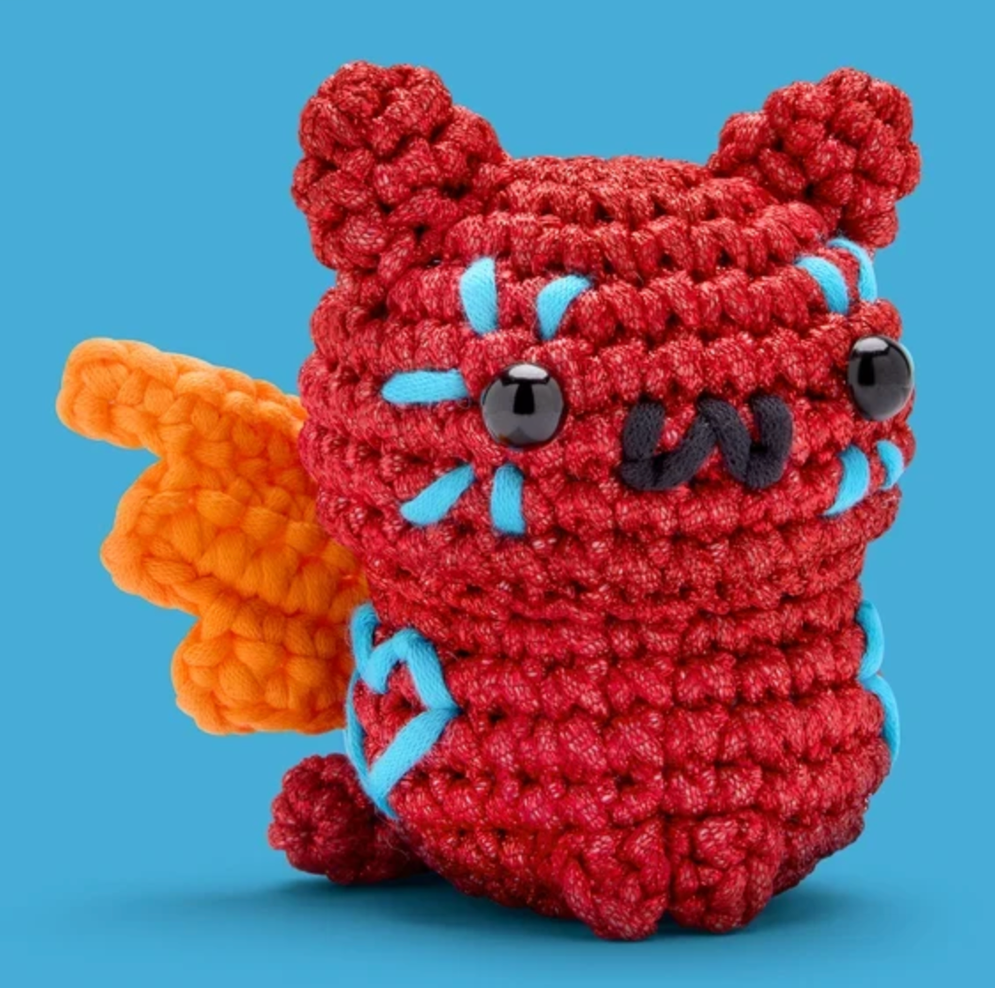 The Woobles Crochet Kit | Maya the Alebrije Cat featuring a red crocheted cat with orange wings