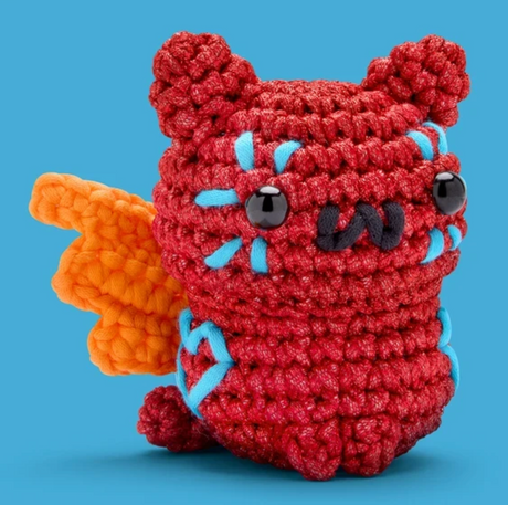 The Woobles Crochet Kit | Maya the Alebrije Cat featuring a red crocheted cat with orange wings