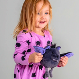 Rolly Bat-Cula plush bat toy held by a smiling child