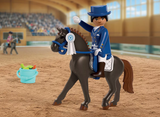 Horses | Equestrian Dressage toy rider on a horse in an indoor arena with a prize ribbon