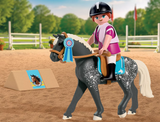 Horses | Equestrian Show Jumping with a rider on a spotted horse in an outdoor arena