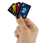 World's Smallest Uno No Mercy cards held in a hand with colorful game cards visible