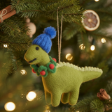 Cozy Dinosaur Felt Ornament featuring a green felt dinosaur wearing a blue hat and festive red and green collar