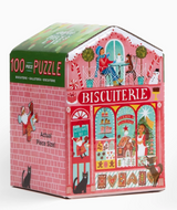 100pc Christmas Market Puzzle in a bakery themed tin with colorful Christmas storefront artwork