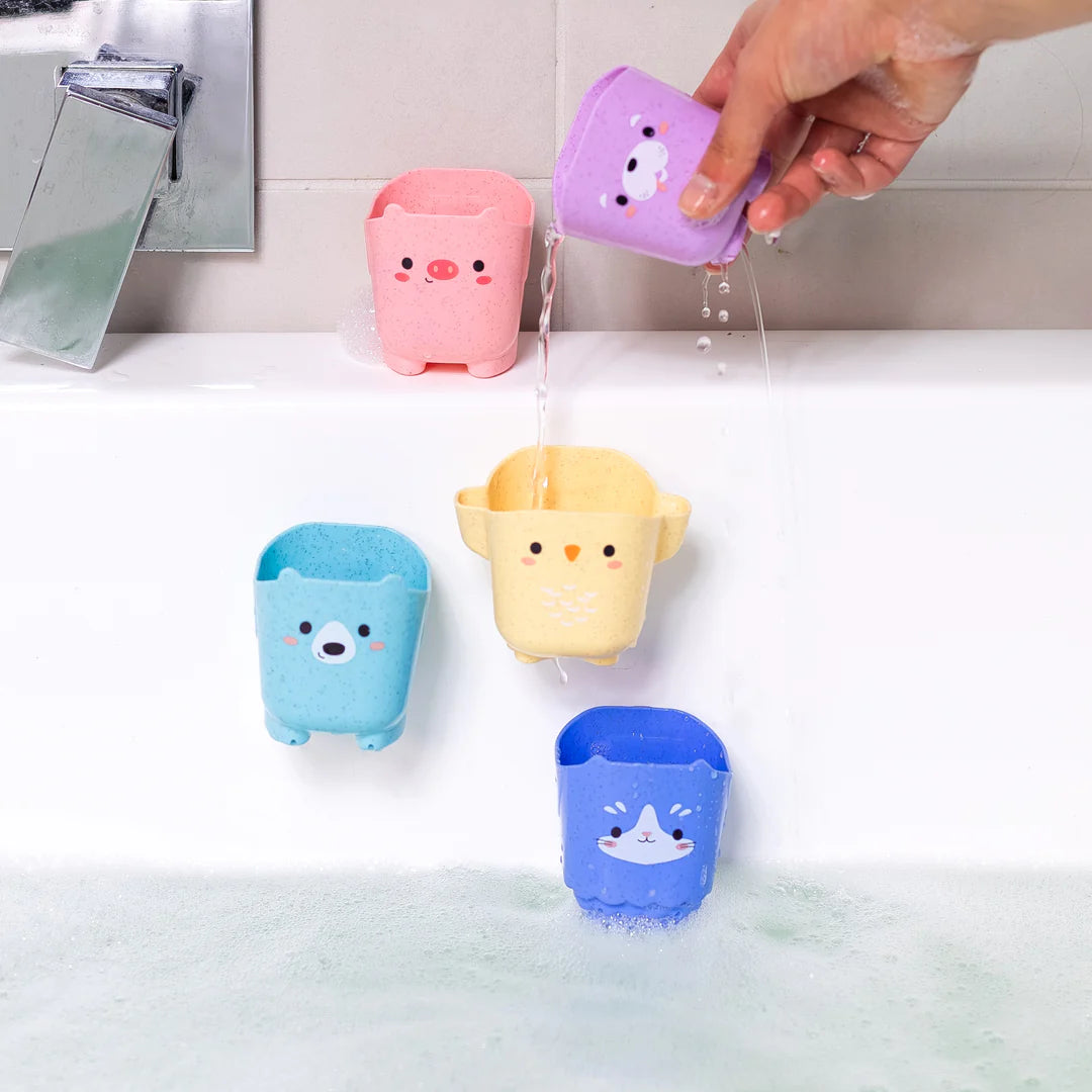 Five colorful animal-shaped cups with suction backs pouring water into a bathtub for bath play fun
