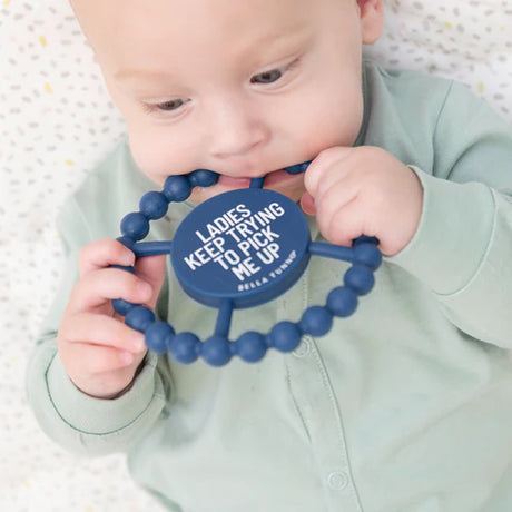 Baby chewing on a navy silicone teether with textured beads for relief, called Teether | Ladies Pick Me Up.