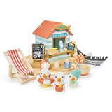 Sandy's Beach Hut wooden toy set with seagulls, fish and chips stall, deck chair, and paper boat for imaginative play.