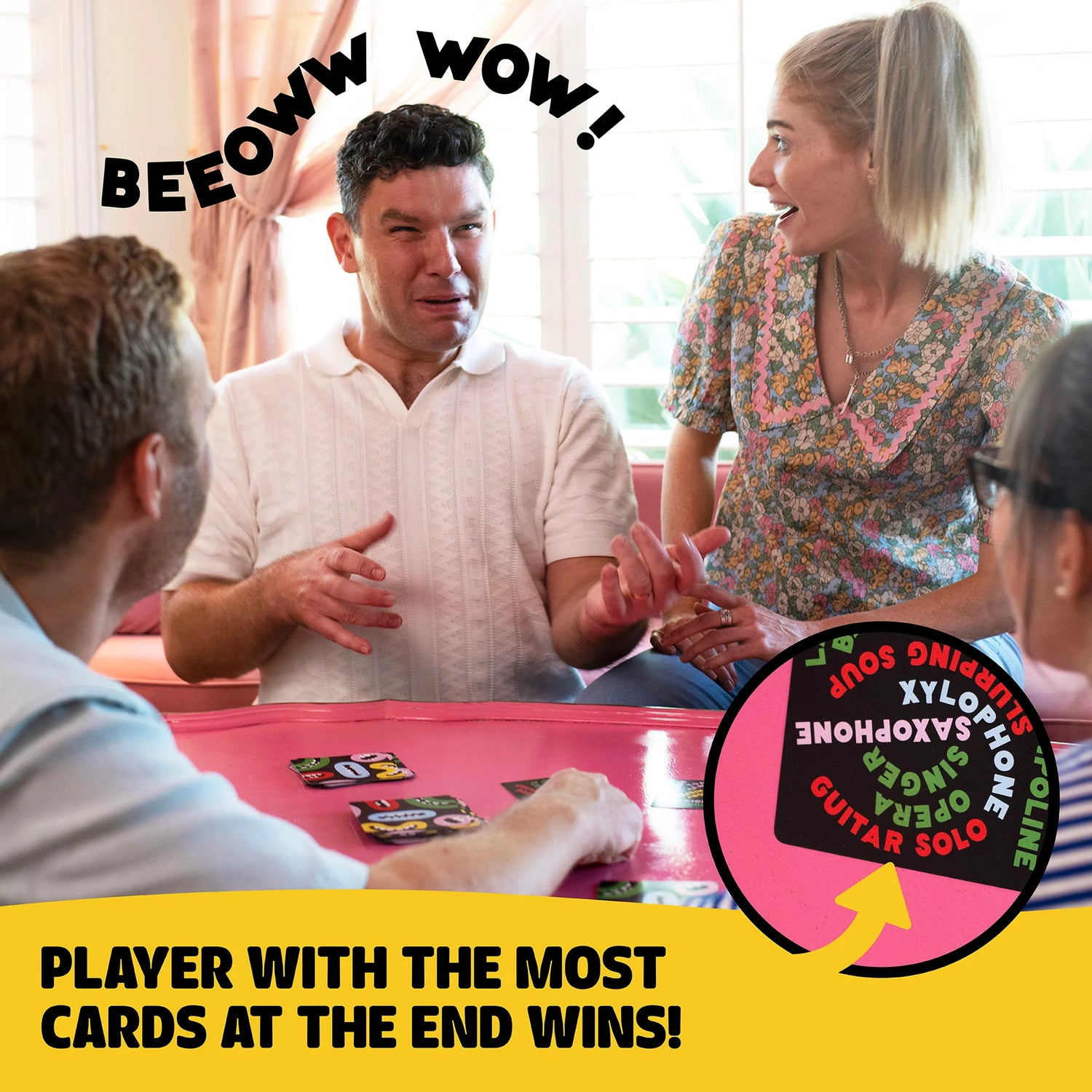 Four friends playing Uproar! card game, laughing and making silly sounds, enjoying a lively game night together.