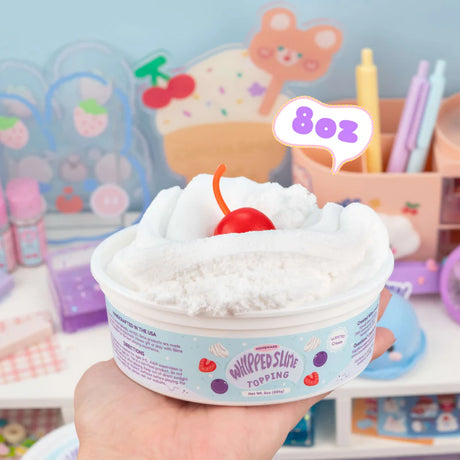 Cool & Slimey Whipped Topping in an 8oz container with a cherry on top, showing its light, airy texture.
