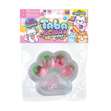 Taba-licious Mega Paws Squishy in clear packaging, paw-shaped with pink and green colors, soft and squeezable toy.