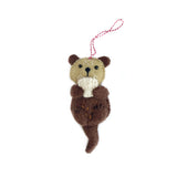 Handmade felt otter ornament in brown and tan wool with stitched details and red striped hanging loop