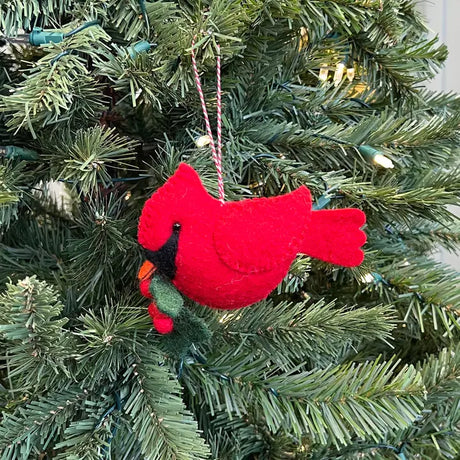 Cardinal with Holly Felt Ornament hanging on a Christmas tree, handmade red felt bird with green holly leaves and berries.