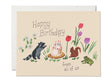 Birthday card featuring raccoon, squirrel, frog, flowers, and a birthday cake with candles on beige background