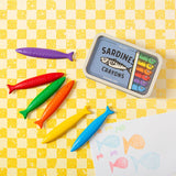 Sardines Crayons colorful fish-shaped crayons in a tin with children's fish drawings