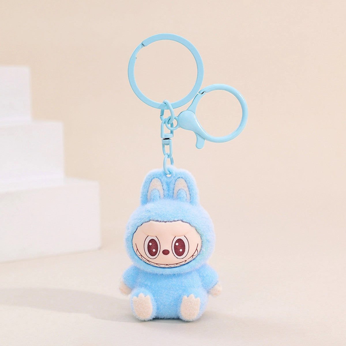 Labubu Flocking Keychain in blue with fuzzy texture and cute smiling character, perfect playful accessory for keys.